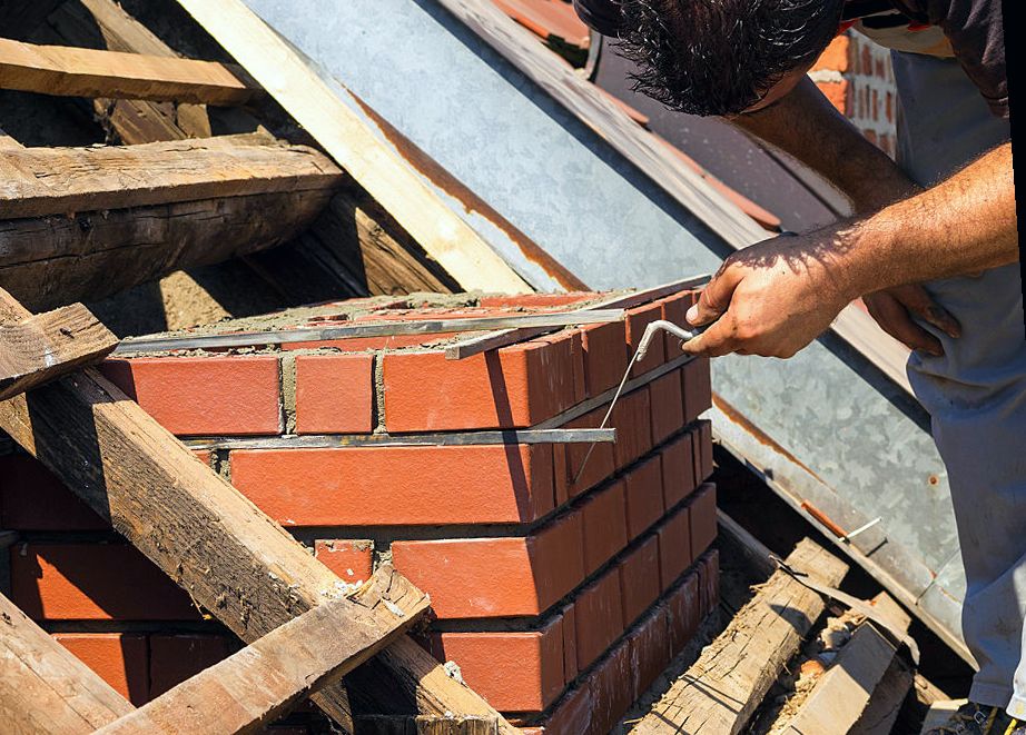 Hoisting brick for fresh courses on a Medford rebuild